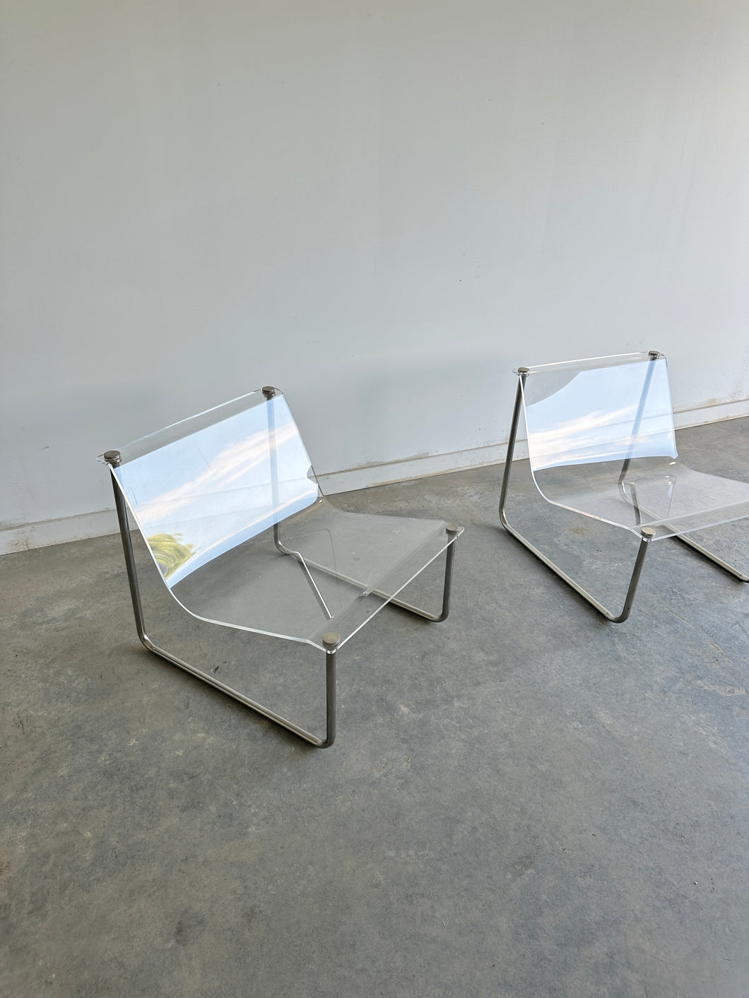 Signed clear lucite and chrome sling chairs
